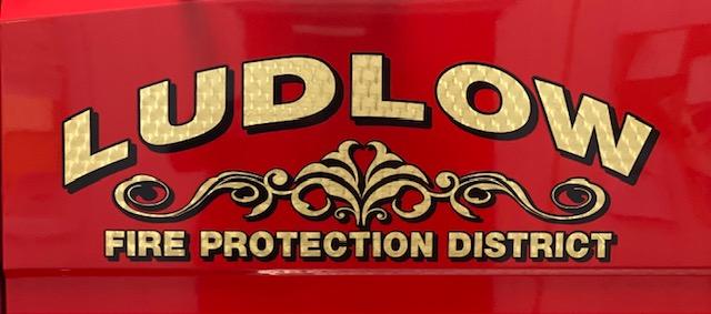 The words Ludlow Fire Protection District on a red background