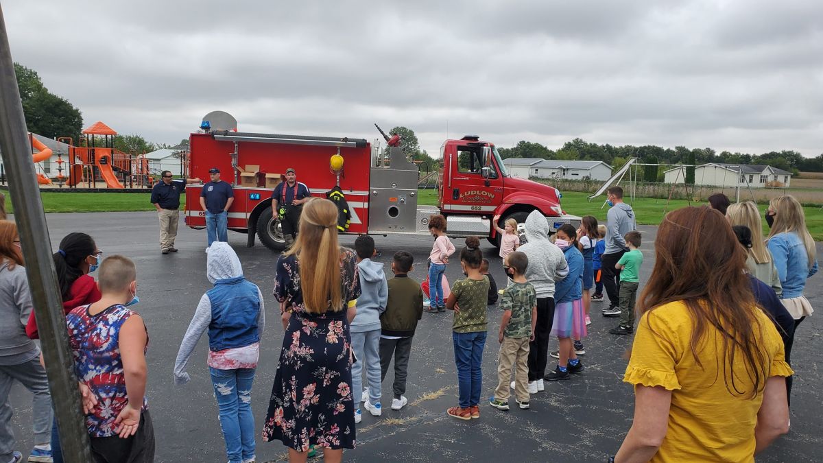 Students and Ludlow Fire Department Personnel gather on the playground for Fire Prevention Week. The students get to see a firetruck as the Ludlow Fire Dept Personnel speak about fire safety.  